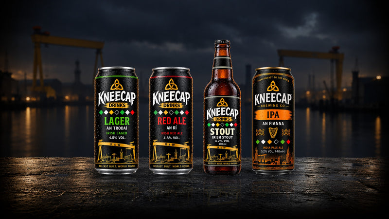 Kneecap Lager, Red Ale, Stout and IPA on a wet Belfast quayside at dusk, Harland & Wolff cranes behind
